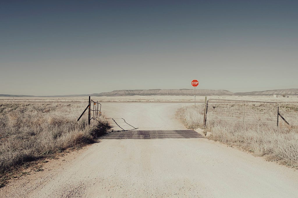 A stop sign alongside Route 66 in Arizona, US, main image to the post “Good to Be Bad” by Martin Wærn.