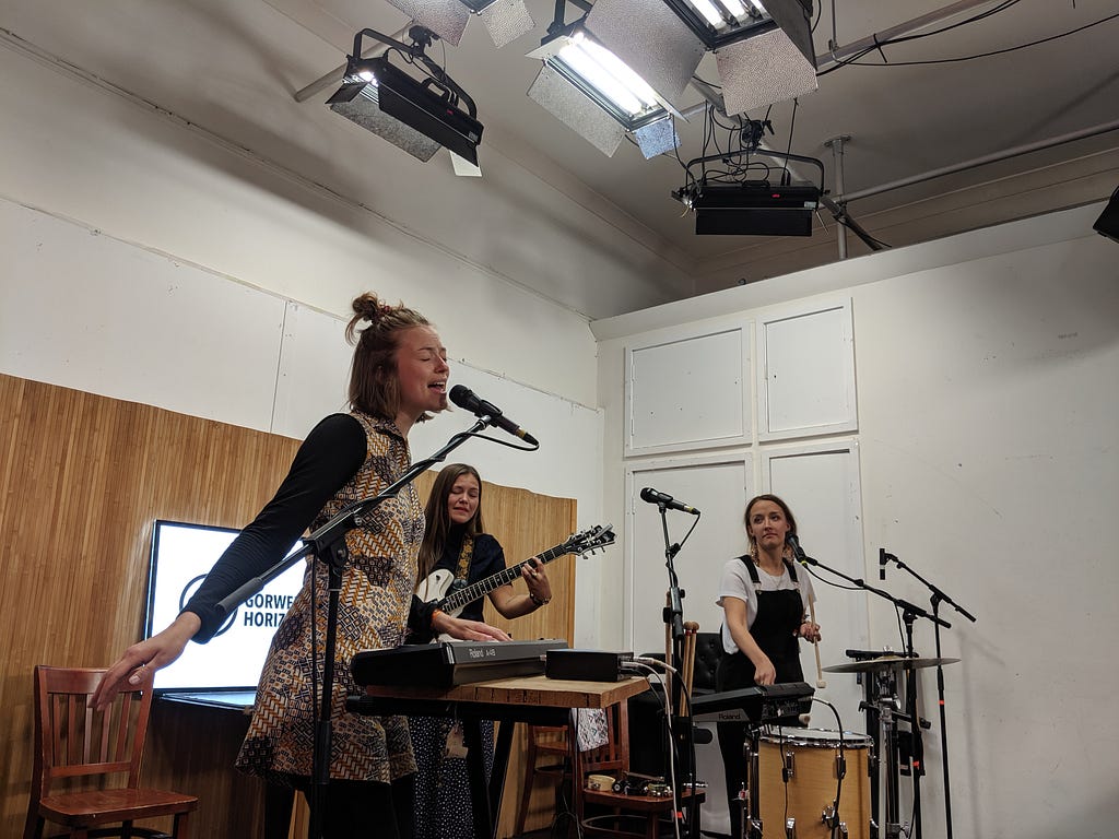 The three female singers from I See Rivers performing