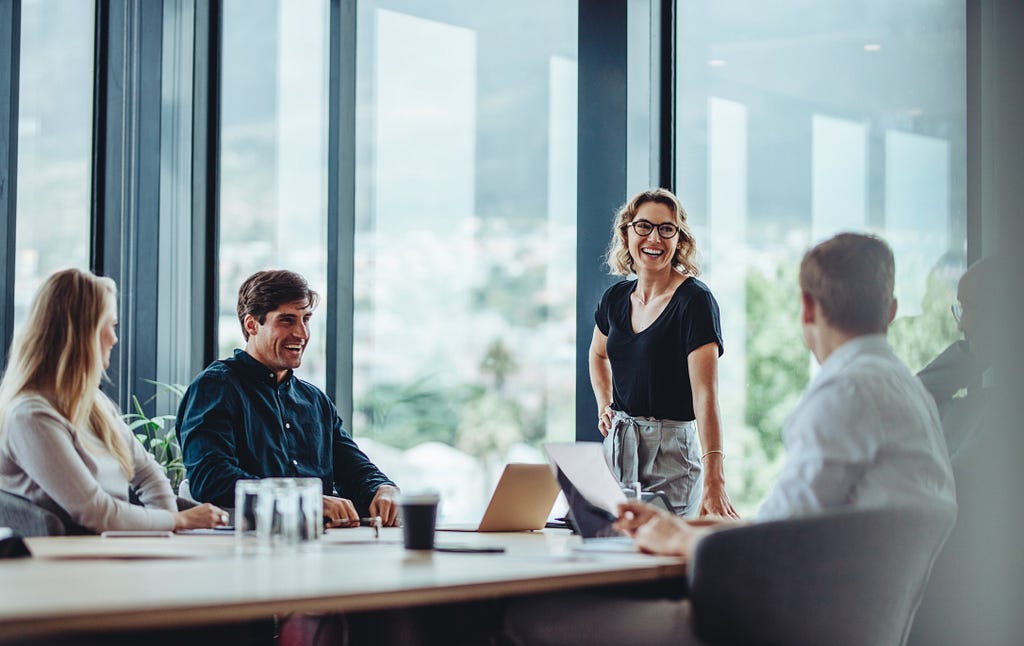 Business people having casual discussion during meeting By Jacob Lund