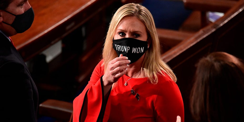 Rep. Marjorie Taylor Greene, R-Ga., wears a “Trump Won” face mask.