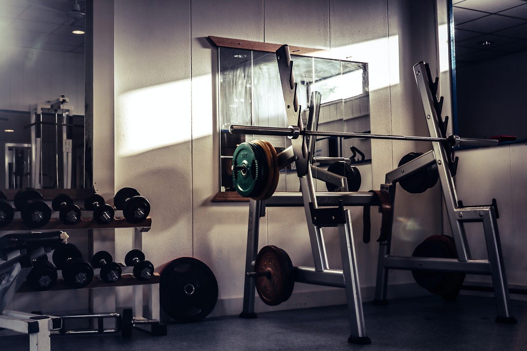 Some dumbbells and other exercise equipment in a gym