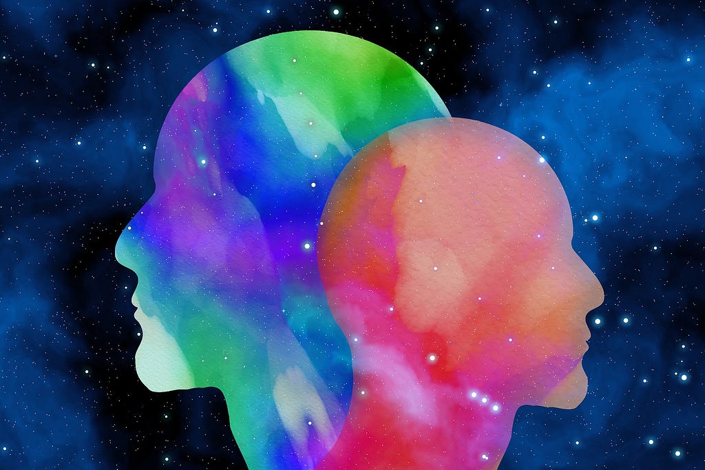 Two human heads with space background