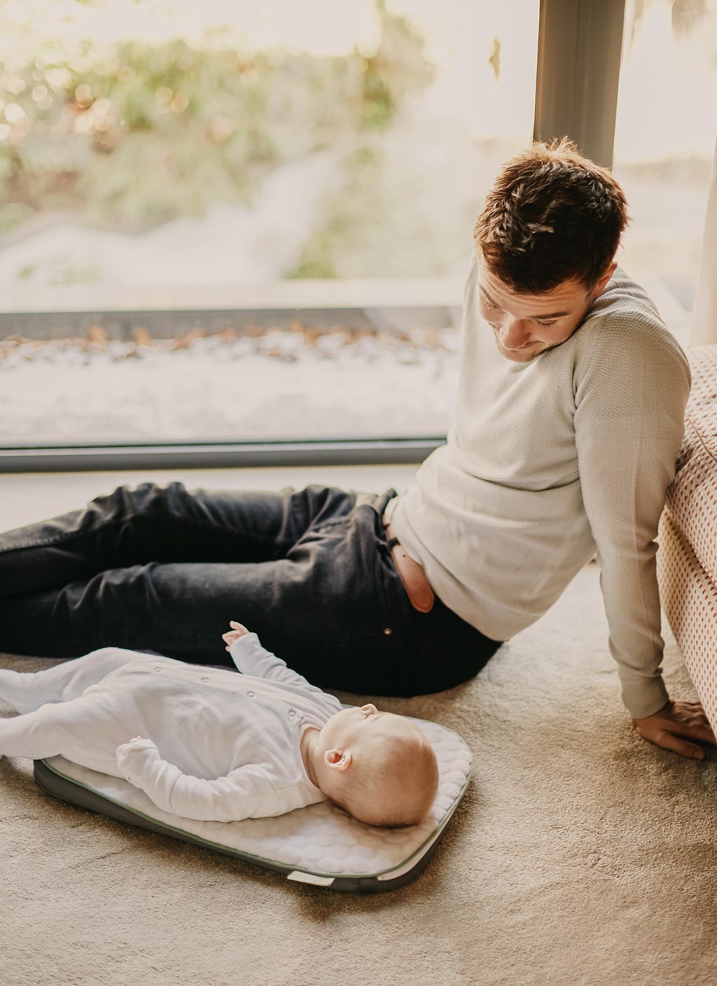 Father looks at infant child while taking time off from work