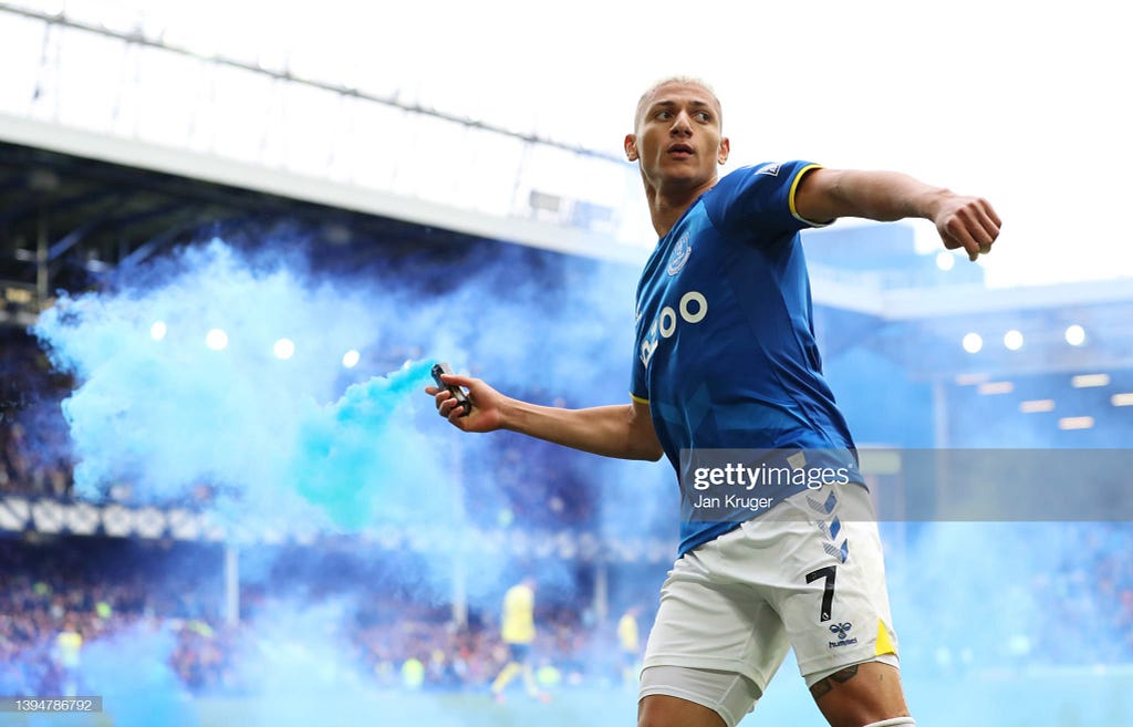 Richarlison throwing blue flair