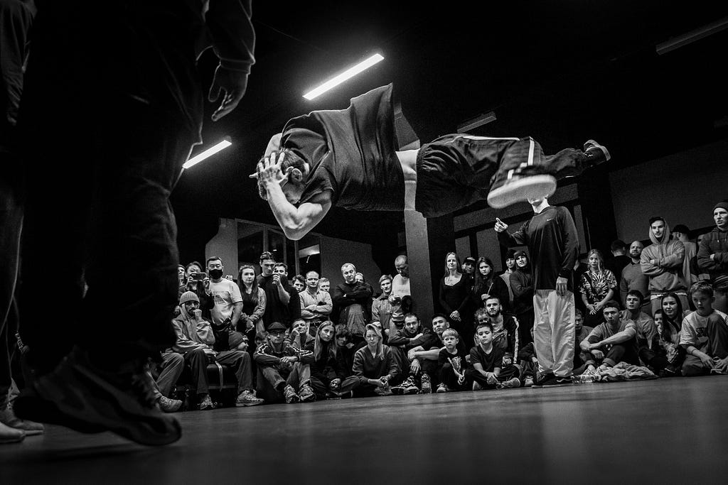 Black and white image of a bboy hitting a freeze mid air.