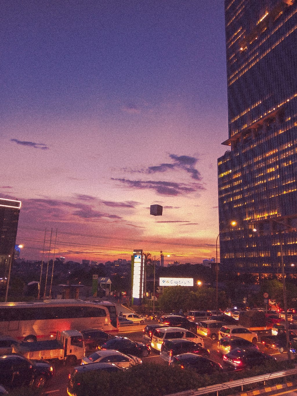 A glimpse of an afternoon city view with a pretty sunset sky in the background.