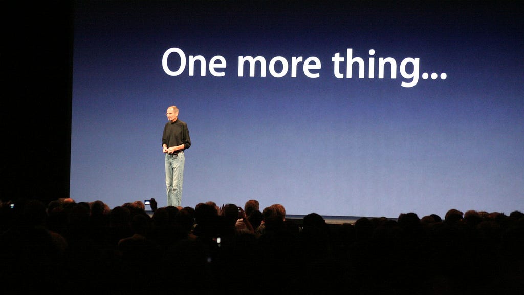 Steve Jobs presenting in front of a screen that says “One more thing…”
