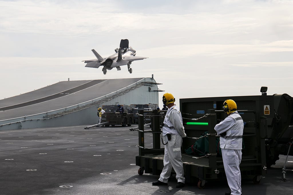 An F-35B fast jet takes off from the flight deck of aircraft carrier HMS Prince of Wales.
