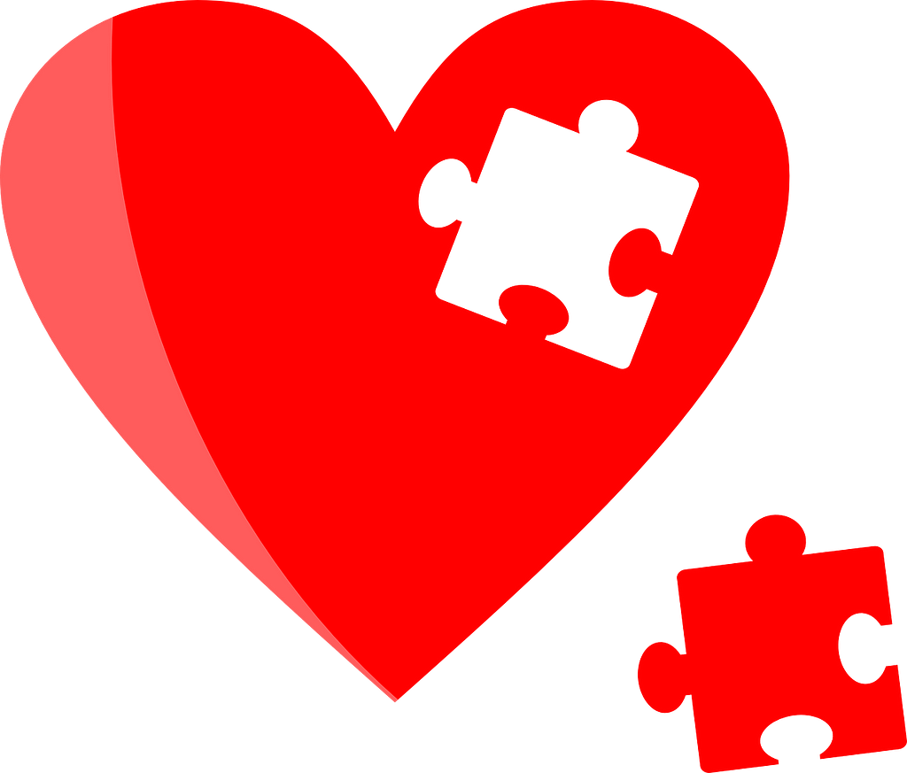 A heart with a puzzle piece missing on the inside. Next to the heart is the missing puzzle piece.