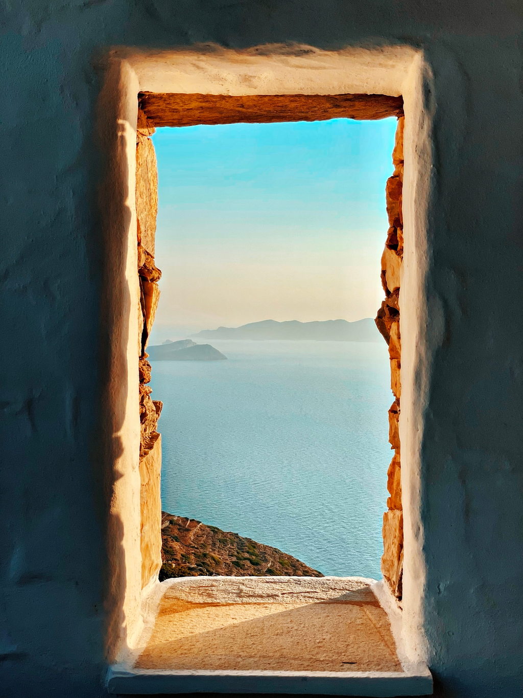 Door leading to a sunny clear landscape