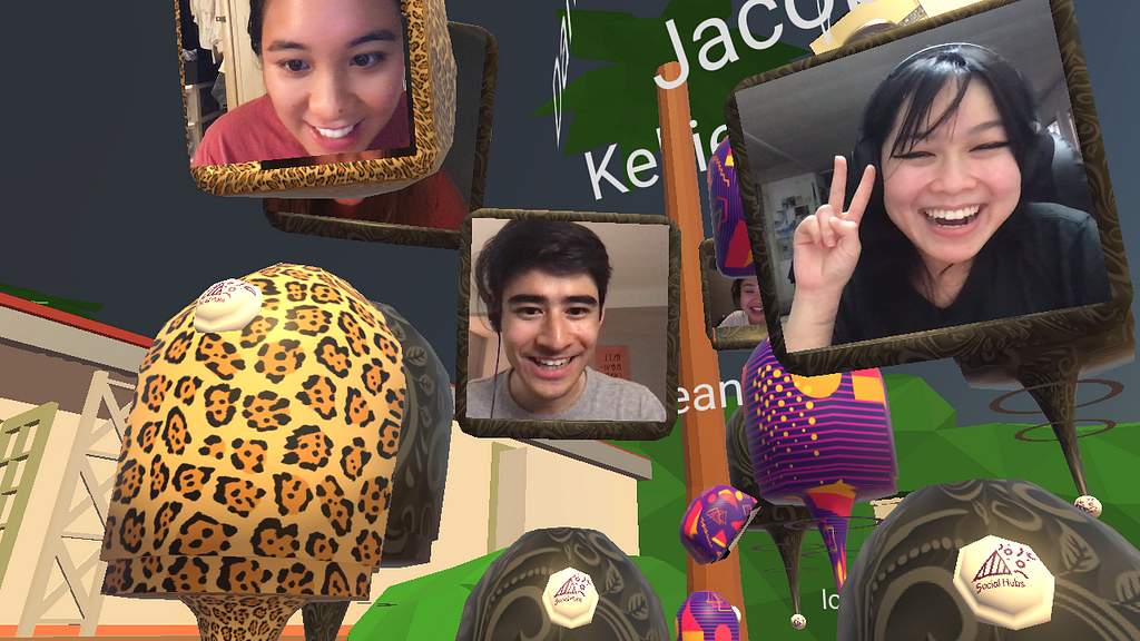 Screenshot of a virtual hangout room. Three people’s faces hover in view, all smiling, one does the peace sign.