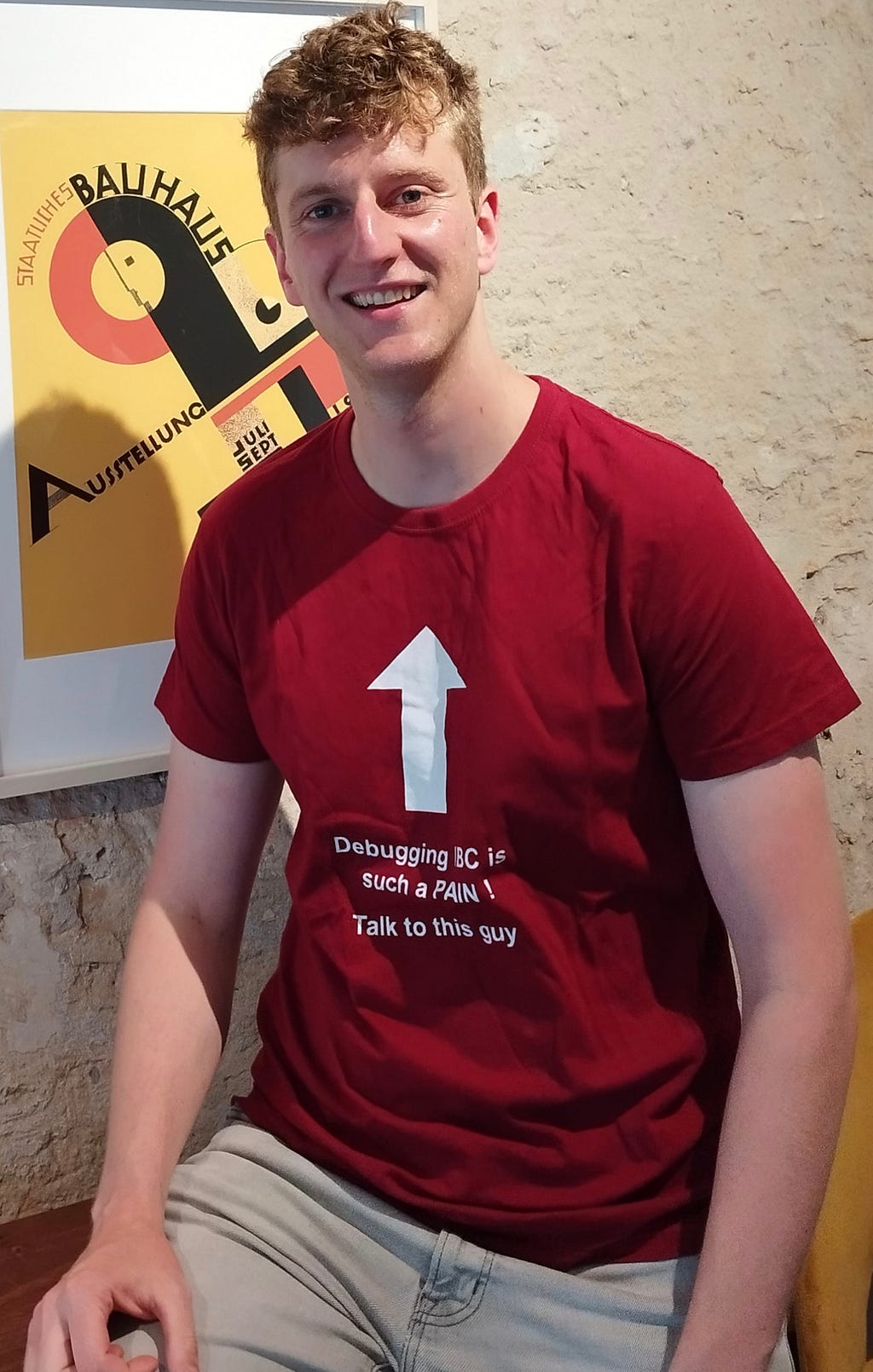 Author of the article wearing a red shirt with the following text : “Debugging IBC is such a Pain ! Talk to this guy” and an arrow from the text to the neck of the t-shirt