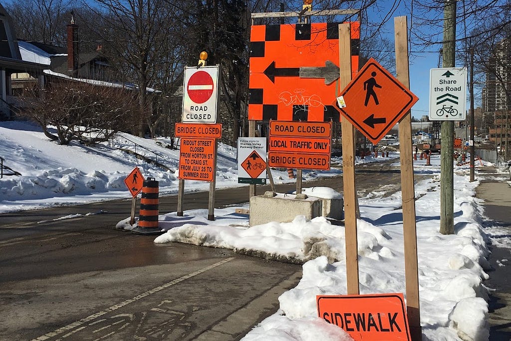 confusing construction signs saying road, bridge, sidewalk closed