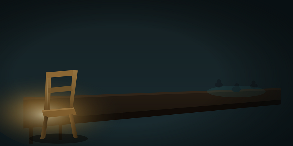 An empty chair at the lit head of a long table while figures further down work with their heads down.