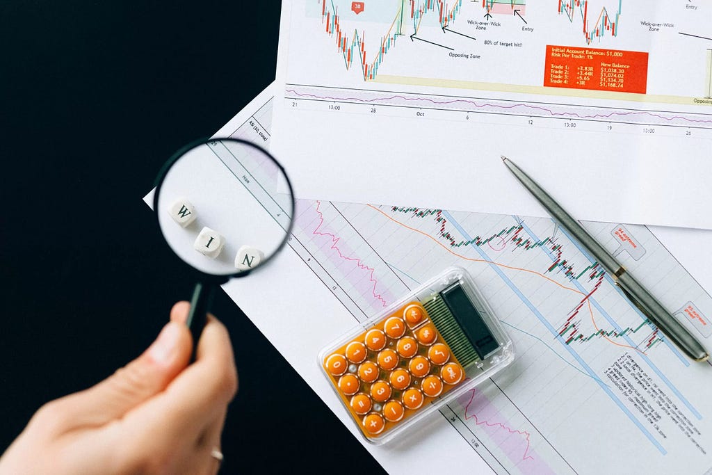 A magnifying glass and a calculator are shown.
