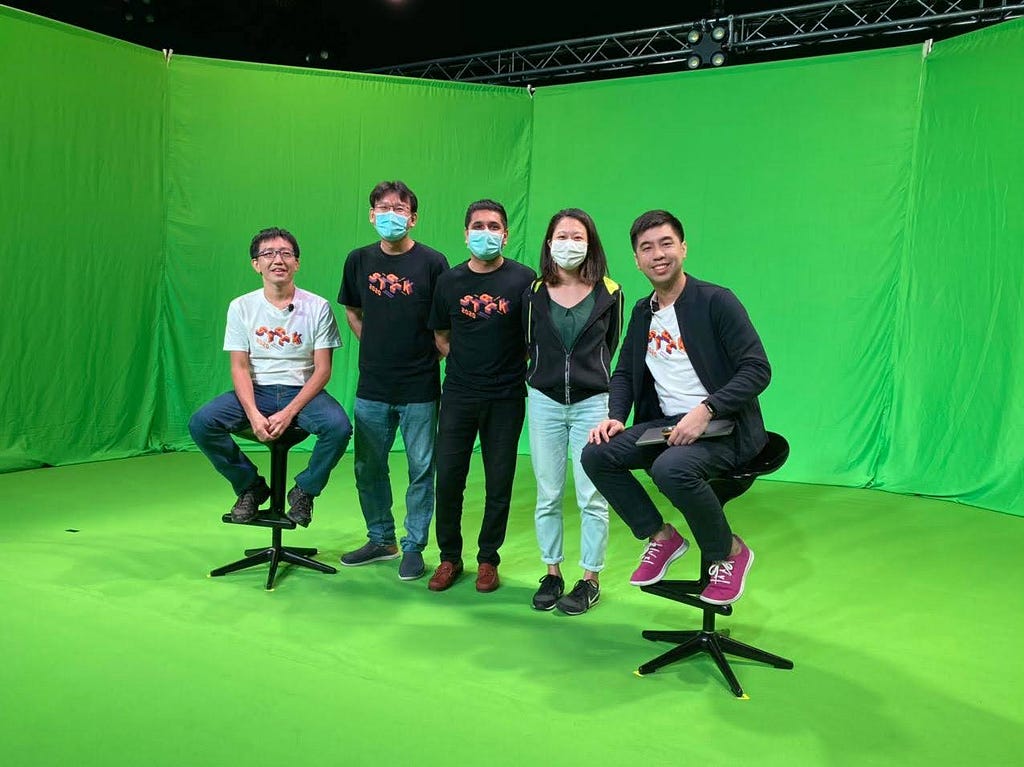 Behind-the-scenes look at the green screen used for recording a panel discussion