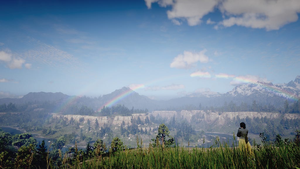 Tilly from Red Dead Redemption 2, standing at a cliffside, looking at mountains with a double rainbow above them.