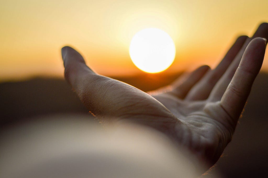 Close-up of an open hand palm up as if they are reaching out.