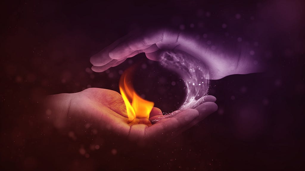 two hands making yin and yang with fire and water