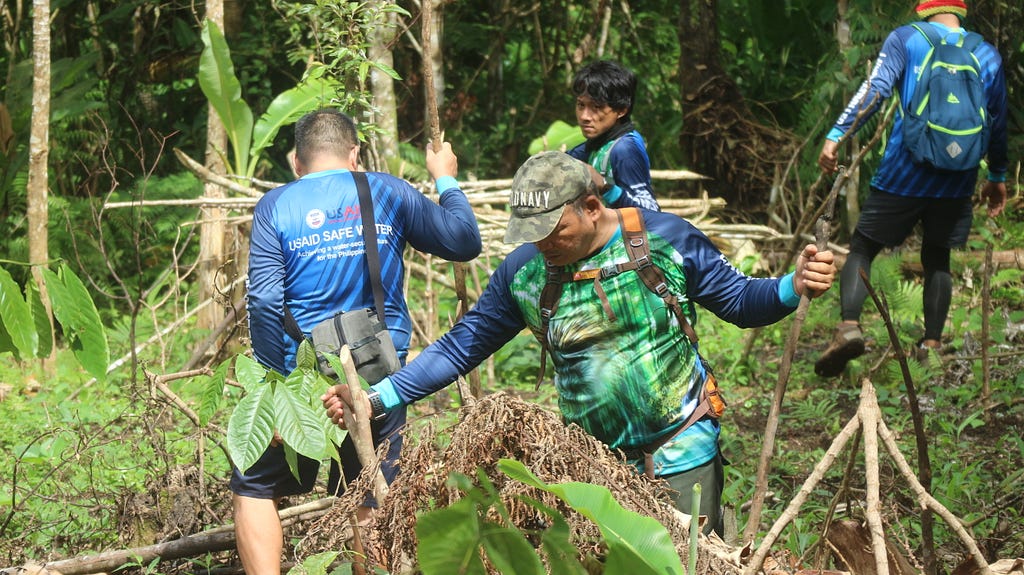 A team of workers dismantles an illegally established hut built on protected lands.