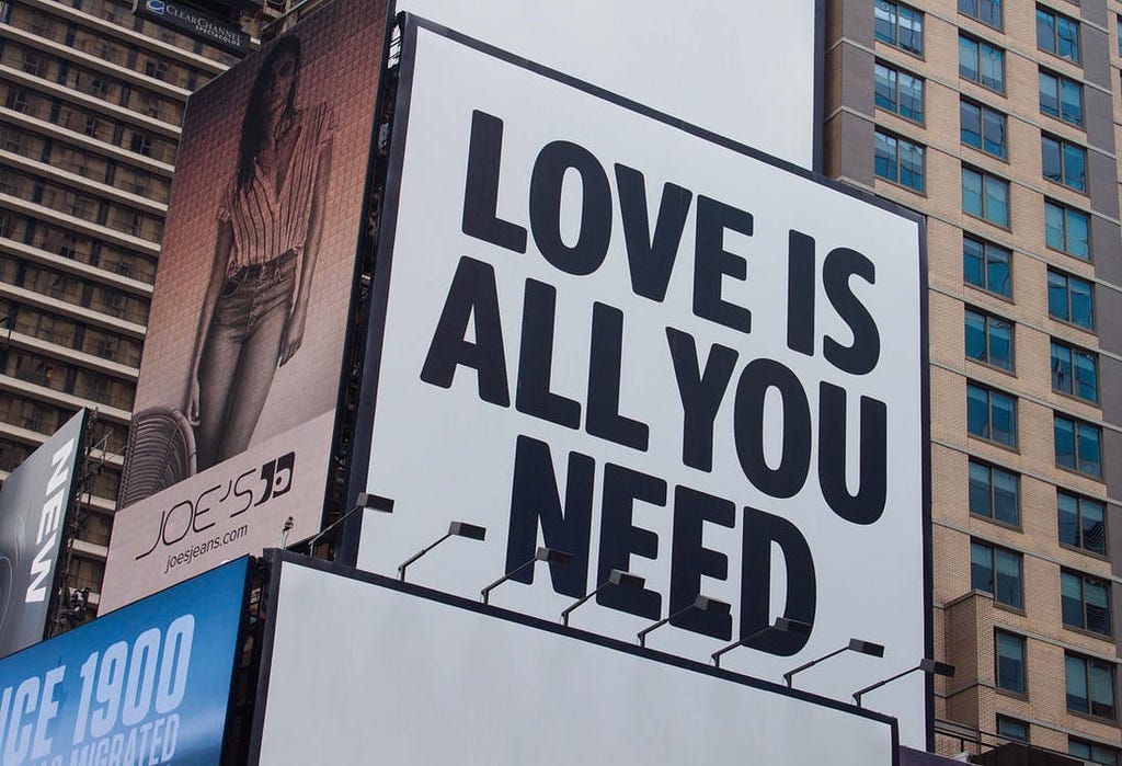 Advertising quotes Love is all you need signage written in famous font