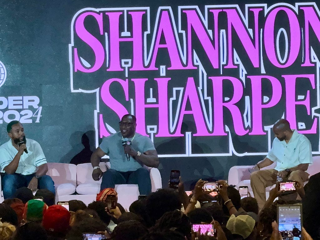 Justin E. Samuels speaks to a packed crowd during an interview with Shannon Sharpe.