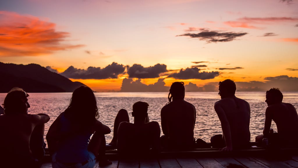A group of friends watching the sunset.