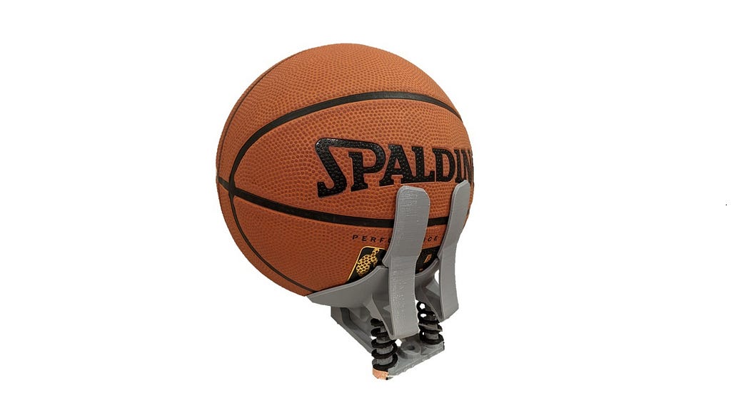 Photo of basketball in a prototype 3D printed baskeball prosthethic hand