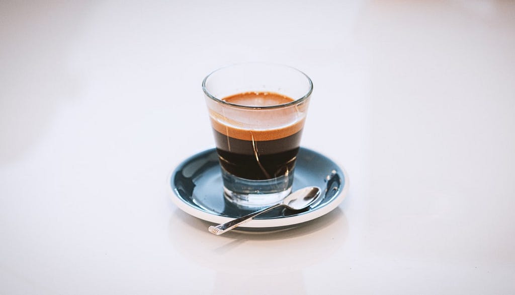 A double espresso served in a glass cup