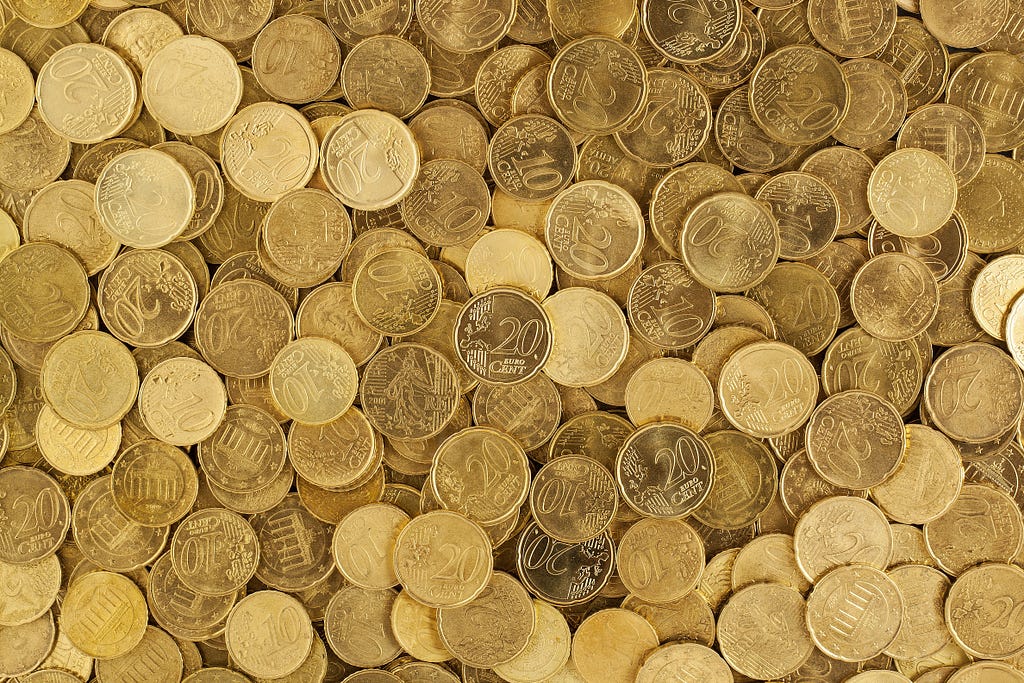 Pile of various gold coins, used as a metaphor for a large quantity of design tokens.