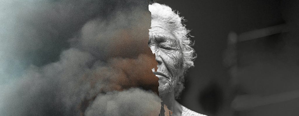 A black and white photo of an older woman’s face, half covered with clouds.