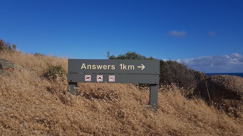 A road sign that reads, “Answers 1km” followed by an arrow.