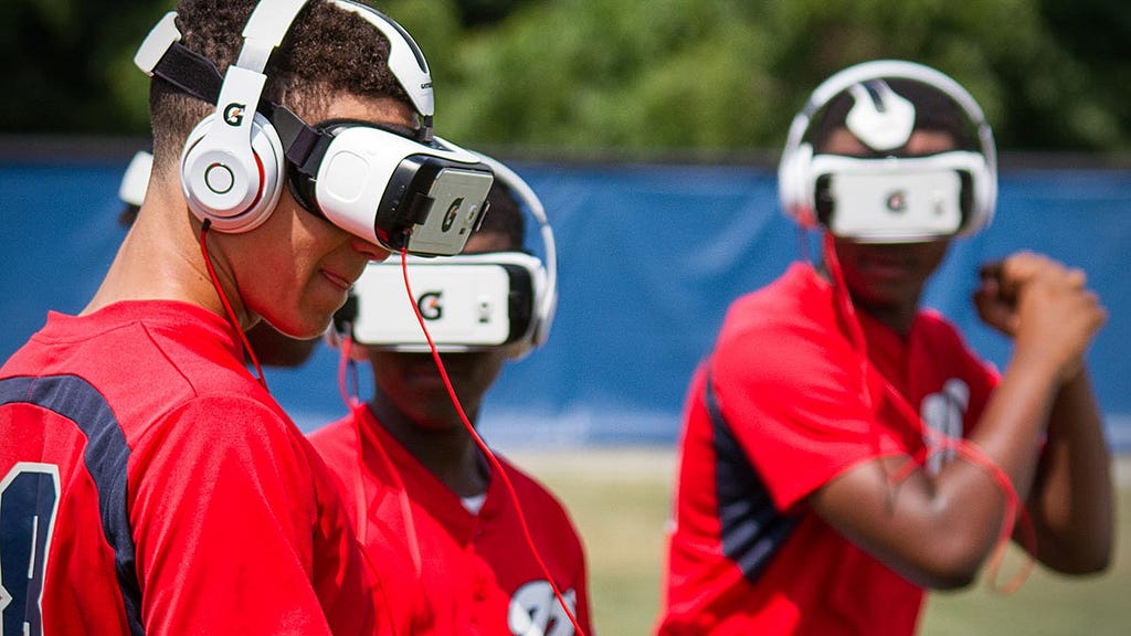 Soccer players wearing virtual reality headset during a training section.