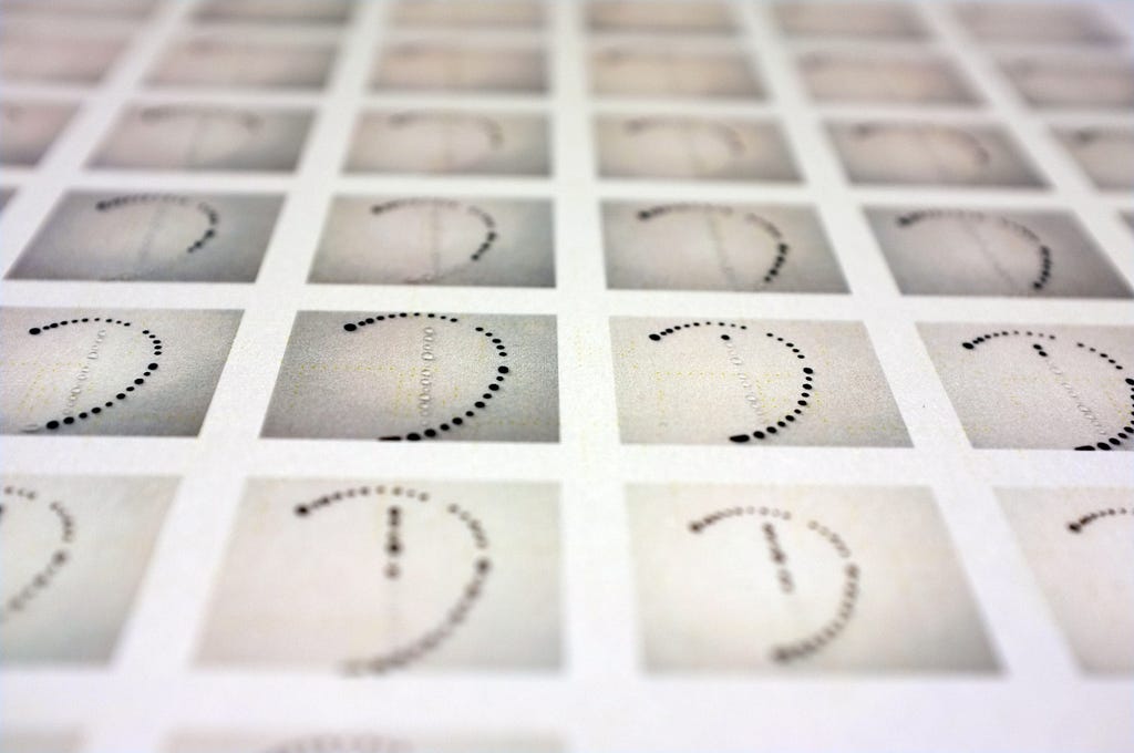 a picture of a row of photos with the letter “D” made out of water drops and ink