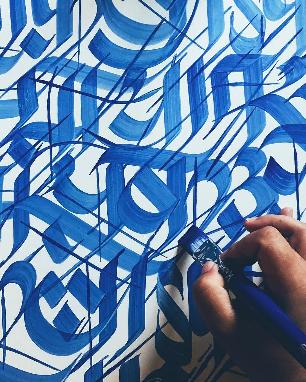 A work in progress of blue, graffiti-style Nepali calligraphy by Imagine, a Nepali artist based in Boston, MA.