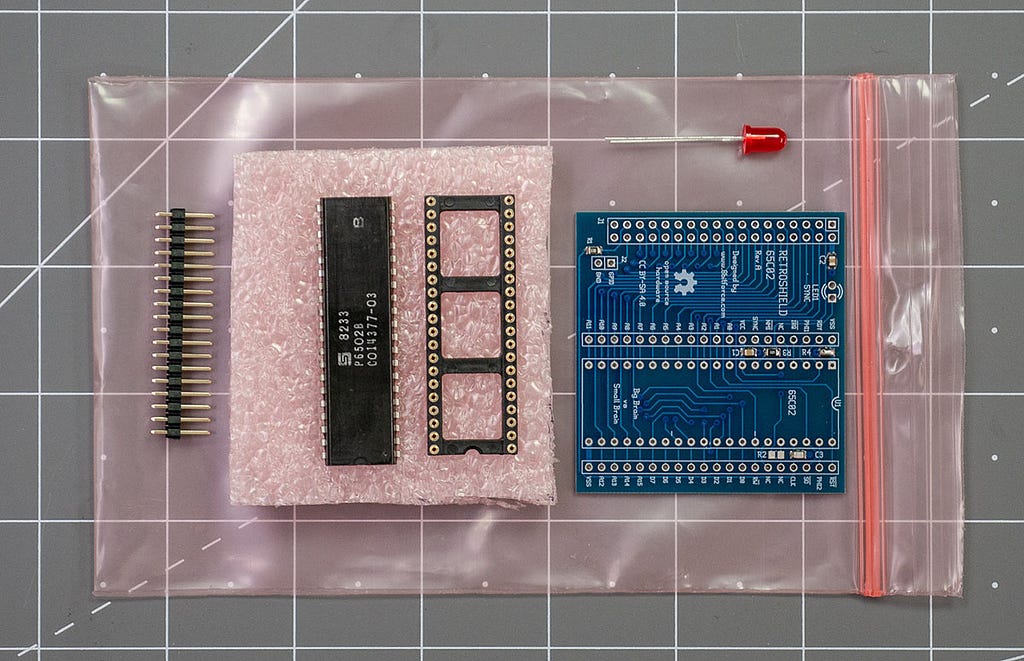 Kit Contents for the RetroShield6502, it is a pcb, processor, socket, and header