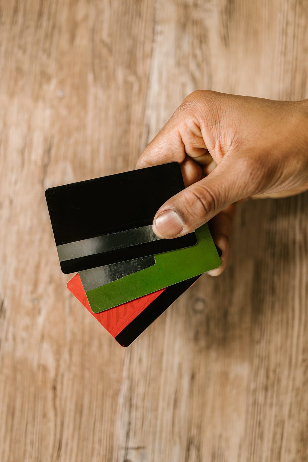 Image of person holding payment cards