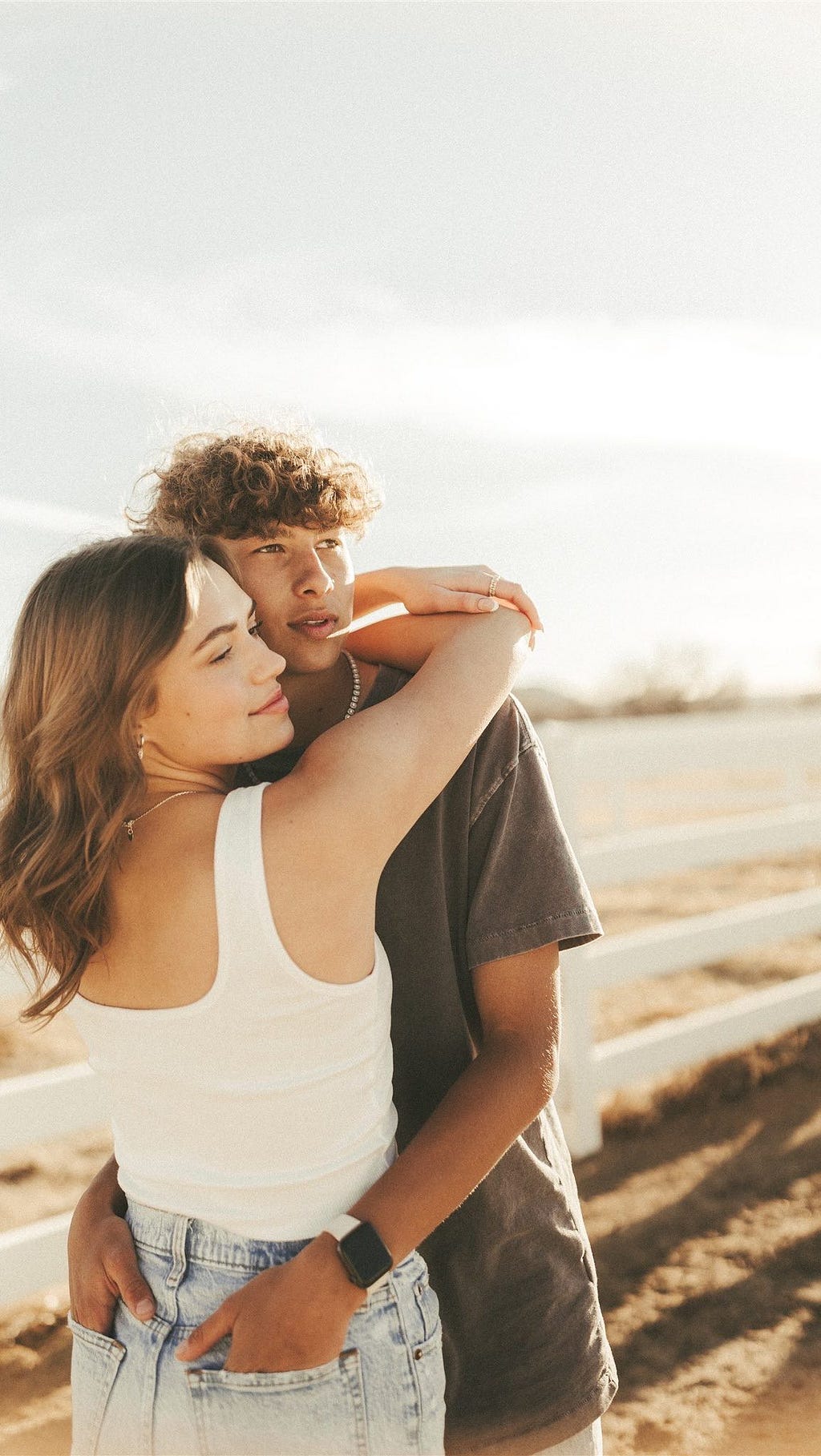 A romantic couple at the beach during sunset