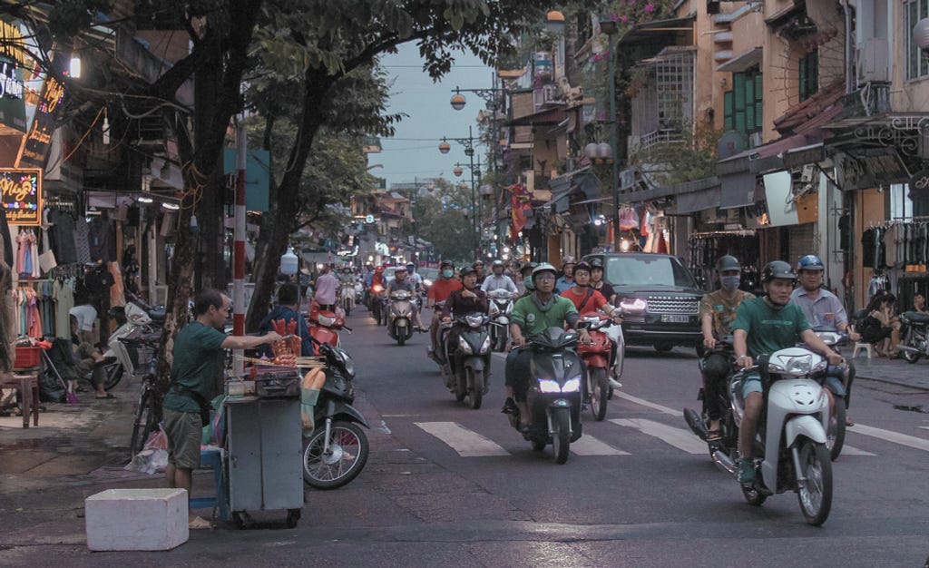 A busy street with lots of motorbikes in Hanoi, Vietnam