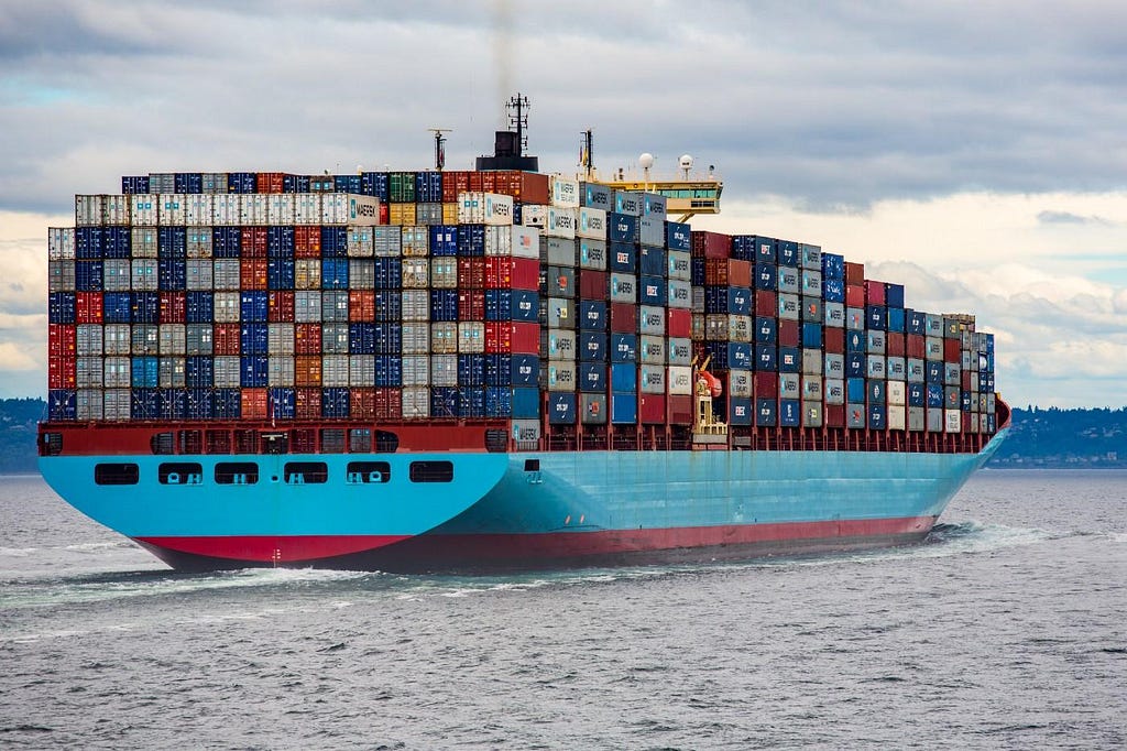 Figure showing blue cargo ship with containers