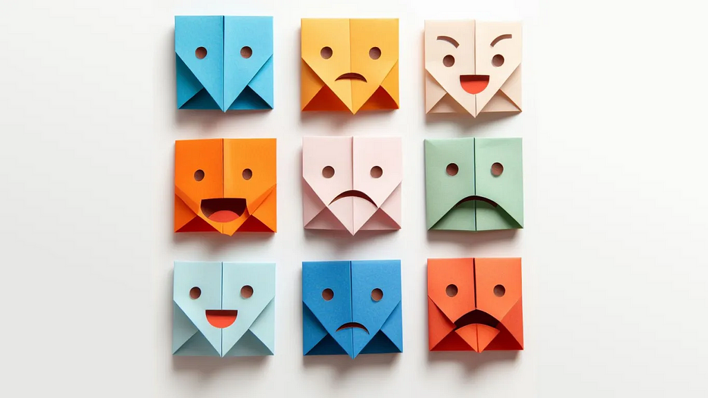 9 folded papers of different pastel colors, each one expressing a different facial emotion