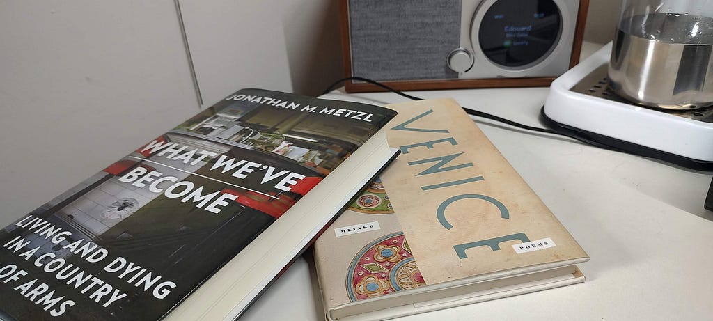 two books on a desk: Jonathan Metzl : What we’ve become, and Ange Mlinko poetry : Venice