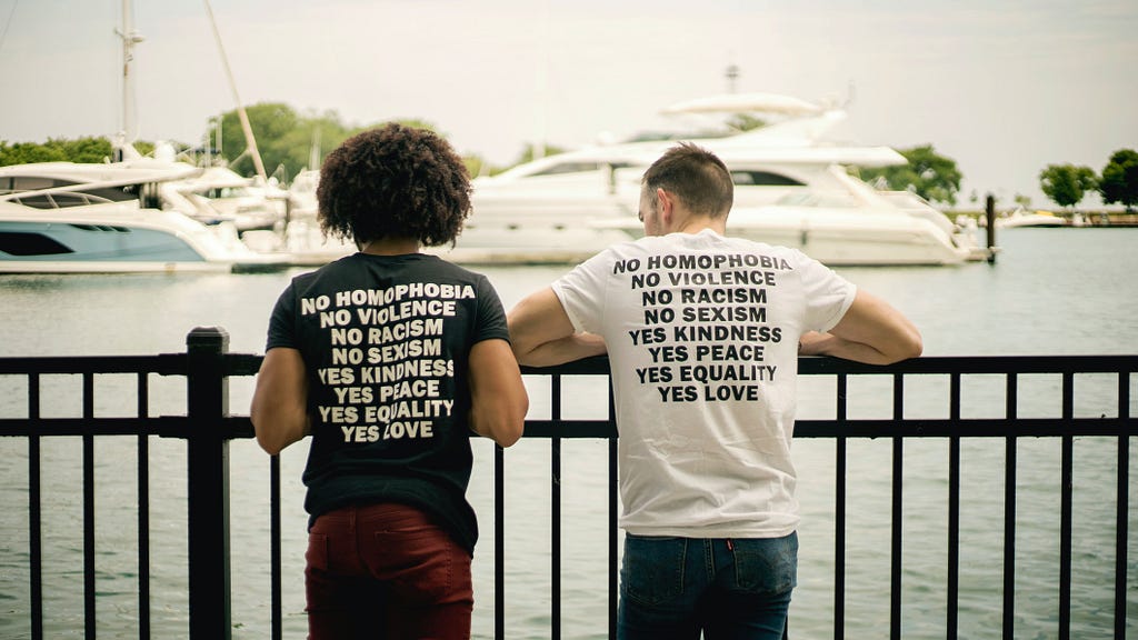 two men wearing promotional t-shirts