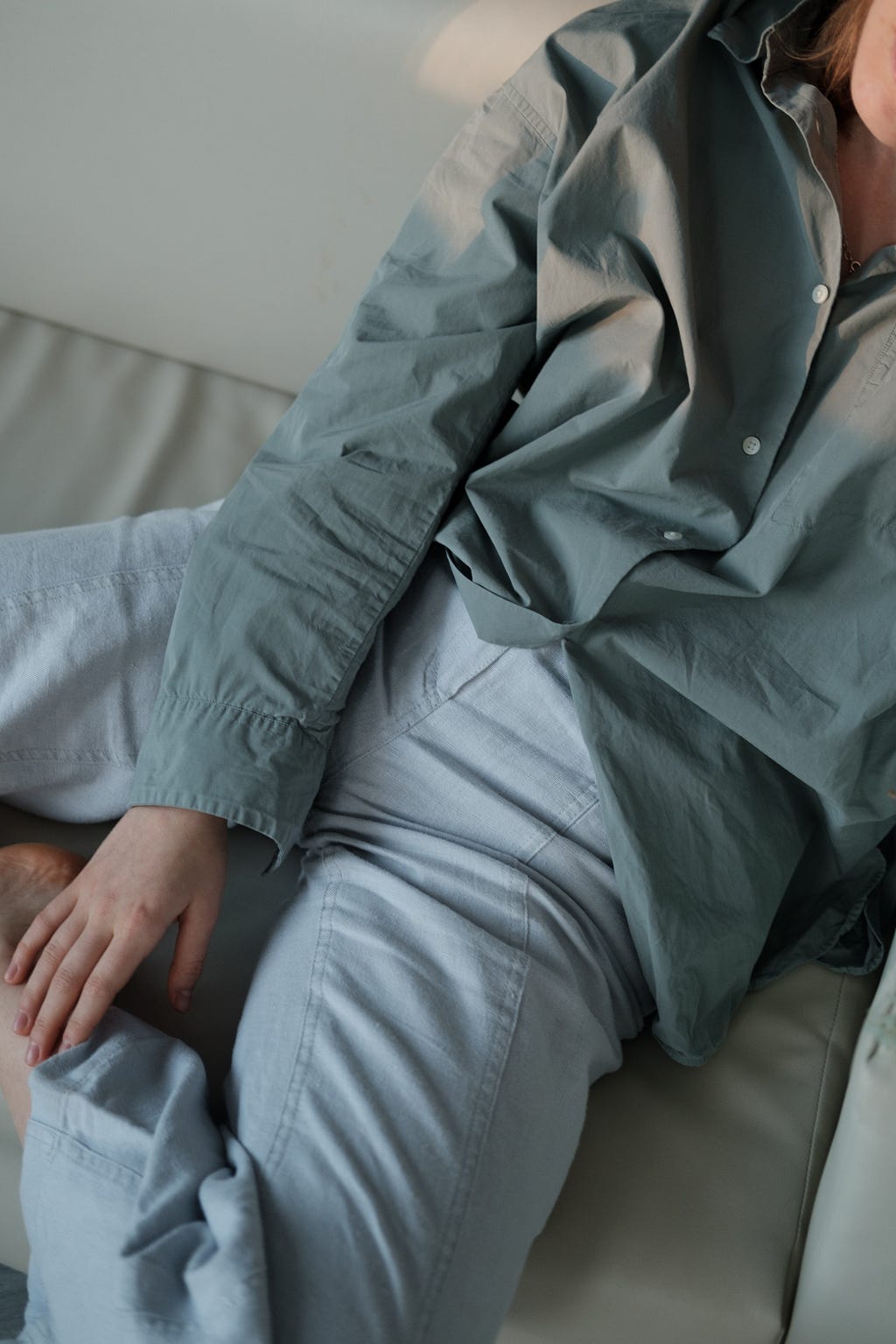 person lounging in light blue pants and top