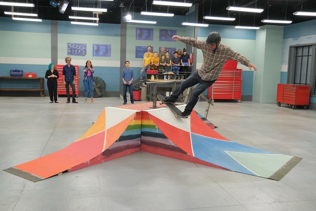 A snippet of the Disney+ show, Shop Class. Professional skateboard Jonas Wray, testing a colorful student built skate ramp.