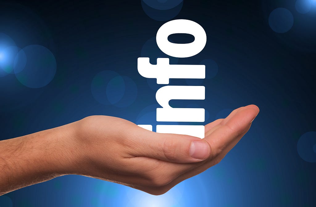 a blue background with a hand stretched out holding the word ‘info’ aligned vertically and resting in the palm of the hand