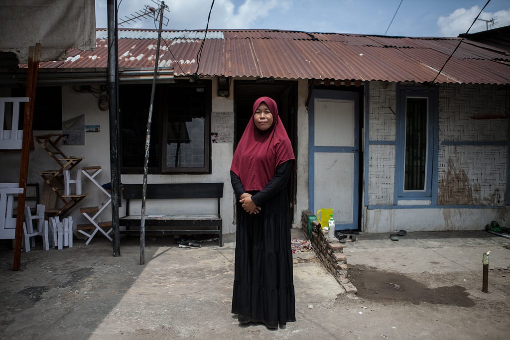 Farida, one of LeaN On program participants, posed in front of her house in Medan, North Sumatra. Photo by Andri Ginting (the photoshoot was done with compliance to health protocol)