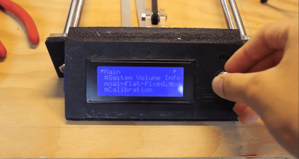 Adjusting settings on a 3D printer’s LCD interface before initiating a print job