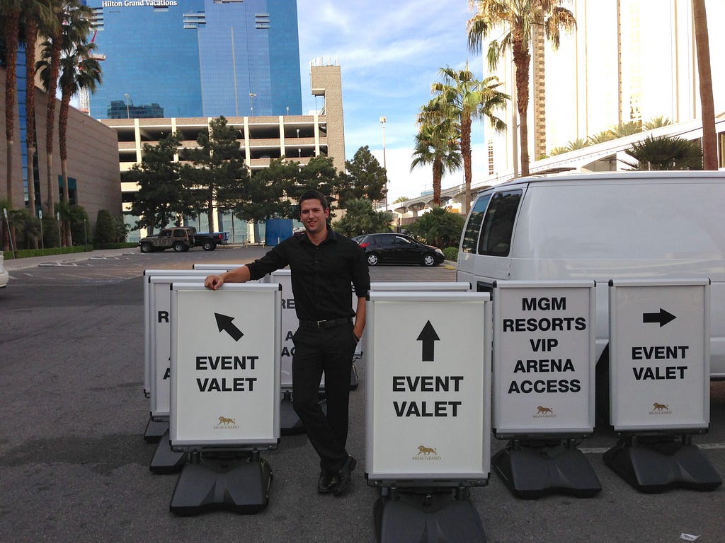 Jeff Kunowski poses with signage produced by his business Illumin-eight.