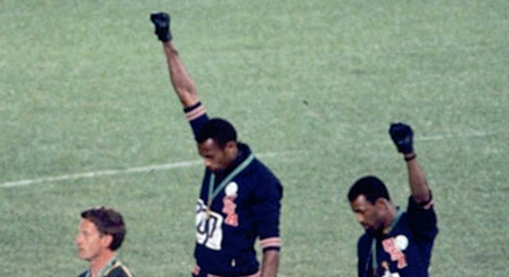 Tommie Smith and John Carlos give the Black Power salute in 1968. Peter Norman at left.